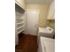 Laundry room features tile look flooring, upper cabinets, and a front loading washer and dryer at 416 Richgold St, Henderson, NV 89012