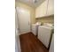 Laundry room features tile look flooring, upper cabinets, and a front loading washer and dryer at 416 Richgold St, Henderson, NV 89012