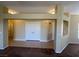 Open-concept living room with neutral paint, neutral flooring and defined columns at 416 Richgold St, Henderson, NV 89012