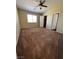 Large main bedroom featuring neutral carpeting, ceiling fan, and dual closets at 416 Richgold St, Henderson, NV 89012