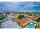 Aerial view of the neighborhood showcasing the home, lush landscaping, and distant mountain views at 4161 Royalhill Ave, Las Vegas, NV 89121