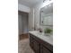 Bathroom view featuring a double sink vanity, tiled floors, and neutral decor at 4161 Royalhill Ave, Las Vegas, NV 89121