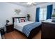 Well-lit bedroom with wood floors, decorative pillows and dresser with decorations at 4161 Royalhill Ave, Las Vegas, NV 89121
