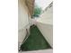 A small, fenced dog run with artificial turf and a cute dog house at 4161 Royalhill Ave, Las Vegas, NV 89121