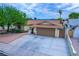 Charming home with a well-maintained lawn, mature trees, and a welcoming two-car garage at 4161 Royalhill Ave, Las Vegas, NV 89121