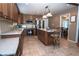 Traditional kitchen features stainless steel appliances, an island, and tile flooring at 4161 Royalhill Ave, Las Vegas, NV 89121
