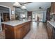 Open kitchen boasts an island, stone countertops, and easy access to the living area at 4161 Royalhill Ave, Las Vegas, NV 89121