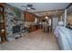 Spacious open concept living room includes fireplace, wooden cabinets and kitchen with island at 4161 Royalhill Ave, Las Vegas, NV 89121