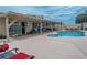 Inviting backyard featuring a private swimming pool, covered patio, and ample seating at 4161 Royalhill Ave, Las Vegas, NV 89121