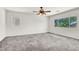 Large bedroom featuring neutral paint, carpet flooring, a ceiling fan and a large window at 4216 Thunder Twice St, Las Vegas, NV 89129