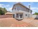 Backyard with brick paver patio, rock landscaping, chimney, and stucco wall at 4657 Curdsen Way, Las Vegas, NV 89110