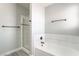 Bathroom featuring a white tiled tub and gray luxury vinyl plank flooring at 4657 Curdsen Way, Las Vegas, NV 89110