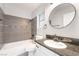 Bathroom featuring a tiled tub and granite countertop vanity at 4657 Curdsen Way, Las Vegas, NV 89110