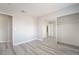 Bedroom with a mirrored closet and gray luxury vinyl plank flooring at 4657 Curdsen Way, Las Vegas, NV 89110