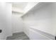 Walk-in closet featuring white shelving, hanging rods, drawers, and gray wood-look flooring at 4657 Curdsen Way, Las Vegas, NV 89110