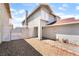 Side view of a two-story home with gated entry and gravel landscaping at 4657 Curdsen Way, Las Vegas, NV 89110