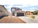 Two-story home featuring a gray exterior and a two-car garage at 4657 Curdsen Way, Las Vegas, NV 89110