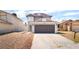 Two-story home featuring a gray exterior and a two-car garage at 4657 Curdsen Way, Las Vegas, NV 89110