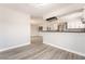 Open-concept view of the living area with stainless steel appliances in the kitchen at 4657 Curdsen Way, Las Vegas, NV 89110