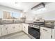 Close-up of the kitchen featuring a stainless steel stove and granite countertops at 4657 Curdsen Way, Las Vegas, NV 89110