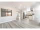 Open-concept living area with wood-look floors flows into the kitchen with stainless appliances at 4657 Curdsen Way, Las Vegas, NV 89110