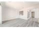 An open-concept living space features wood-look floors, recessed lighting, and neutral paint at 4657 Curdsen Way, Las Vegas, NV 89110