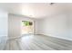 Bright, open living room with wood-look floors and sliding glass doors to the backyard at 4657 Curdsen Way, Las Vegas, NV 89110