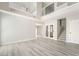 Bright, modern living room with high ceilings and light wood-look floors at 4657 Curdsen Way, Las Vegas, NV 89110