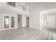 Bright, modern living room with high ceilings and light wood-look floors at 4657 Curdsen Way, Las Vegas, NV 89110