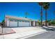Charming single-story home featuring a two-car garage, mature landscaping, and blue skies in a quiet neighborhood at 4774 Walteta Way, Las Vegas, NV 89119