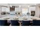 Modern kitchen with a large island, breakfast bar, sleek countertops, and stainless steel appliances at 4774 Walteta Way, Las Vegas, NV 89119