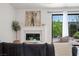 Bright living room with modern fireplace, designer accents, and view to the outdoor landscape at 4774 Walteta Way, Las Vegas, NV 89119