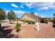 Large backyard with rock landscaping and a covered patio, perfect for entertaining guests at 4909 Desert Poppy Dr, Las Vegas, NV 89130