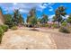 Spacious backyard with rock landscaping, mature trees, and ample room for outdoor activities at 4909 Desert Poppy Dr, Las Vegas, NV 89130