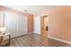 Empty bedroom featuring laminate floors, double closet, and entry to the ensuite bathroom at 4909 Desert Poppy Dr, Las Vegas, NV 89130
