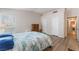 Bright primary bedroom with laminate floors, large window, and ensuite bathroom at 4909 Desert Poppy Dr, Las Vegas, NV 89130