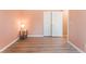 Empty bedroom with laminate floors and access to ensuite bathroom at 4909 Desert Poppy Dr, Las Vegas, NV 89130
