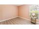 Bright bedroom with a window offering ample natural light and laminate wood flooring at 4909 Desert Poppy Dr, Las Vegas, NV 89130