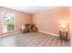 Empty bedroom with laminate floors and a bright window at 4909 Desert Poppy Dr, Las Vegas, NV 89130