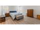 Spacious bedroom featuring hardwood floors, natural light, and stylish furnishings at 4909 Desert Poppy Dr, Las Vegas, NV 89130