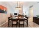Well-lit dining room with modern decor, light wood floors, and a seamless transition to other living spaces at 4909 Desert Poppy Dr, Las Vegas, NV 89130