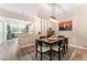 Inviting dining area featuring a modern light fixture and seamless flow into the adjacent kitchen at 4909 Desert Poppy Dr, Las Vegas, NV 89130