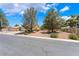 Well-maintained single-story home with mature trees and a low-maintenance desert landscape at 4909 Desert Poppy Dr, Las Vegas, NV 89130