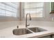 Close-up of a stainless steel kitchen sink with modern faucet and ample counter space at 4909 Desert Poppy Dr, Las Vegas, NV 89130