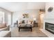 Inviting living room features neutral colors, a vaulted ceiling, and cozy fireplace with mantle at 4909 Desert Poppy Dr, Las Vegas, NV 89130
