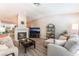 Bright living room features wood floors, a comfortable seating arrangement, and a fireplace at 4909 Desert Poppy Dr, Las Vegas, NV 89130