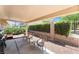 Underneath a covered patio are three tan patio chairs at 4909 Desert Poppy Dr, Las Vegas, NV 89130