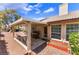 Relaxing covered patio with seating, grill, and access to the home's interior at 4909 Desert Poppy Dr, Las Vegas, NV 89130