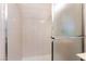 Tiled shower featuring glass sliding doors and chrome hardware at 4909 Desert Poppy Dr, Las Vegas, NV 89130