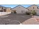 Desert-landscaped backyard with a covered patio and view of the home's exterior at 4916 White Jade St, North Las Vegas, NV 89081